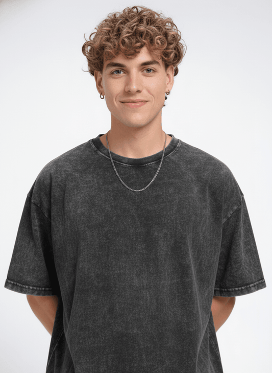 Men's black acid wash T-shirt from Outlaws, featuring a casual fit and vintage-style distressed fabric.