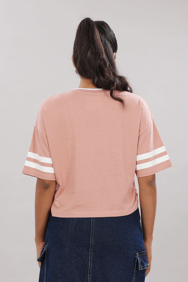 Pink cotton boxy top for women with extended sleeves by Outlaws Fashion, shown on a model with a relaxed fit.
