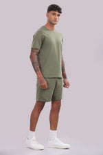 Men’s olive green co-ord set from Outlaws Fashion featuring a comfortable matching sweatshirt and joggers for everyday wear.