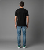 Men’s Outlaws Christmas printed T-shirt featuring festive holiday design and 100% cotton casual wear, shown on a model.