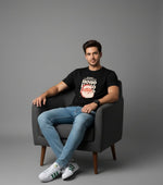 Men’s Outlaws Christmas printed T-shirt featuring festive holiday design, 100% cotton casual wear, shown on a model.