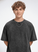 Men's black acid wash T-shirt from Outlaws, featuring a casual fit and vintage-style distressed fabric.
