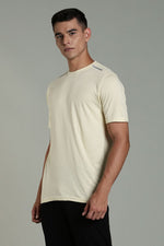 Beige Outlaws Fashion men's athleisure T-shirt displayed on a hanger, casual style with a relaxed fit and subtle branding.