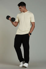 Beige Outlaws Fashion men's athleisure T-shirt with a relaxed fit and crew neckline, displayed on a hanger.