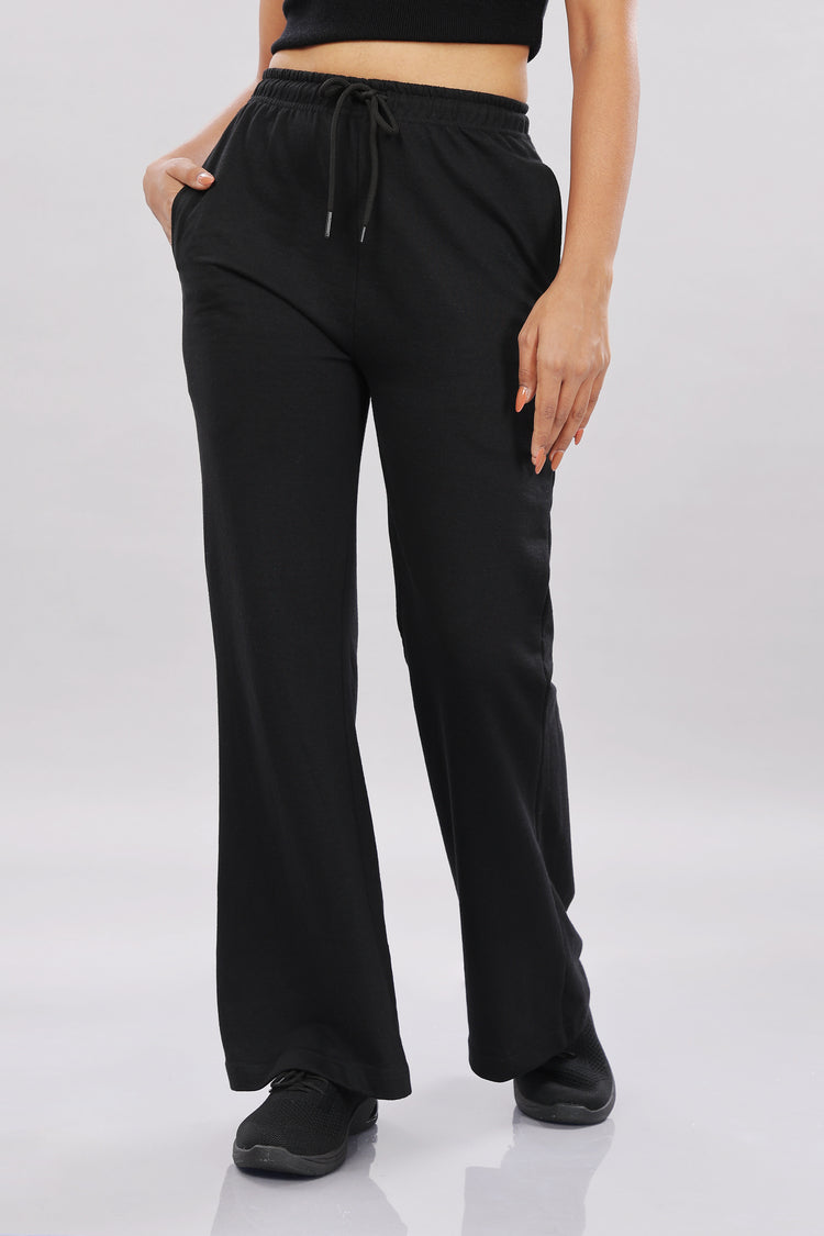 Outlaws Fashion women's black track pants with a relaxed fit, featuring elastic waistband and tapered legs for athletic and casual wear.