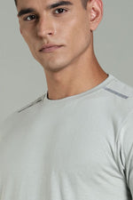 Light grey men's athleisure T-shirt from Outlaws Fashion, casual fit with crew neckline and sporty style, shown on a model.