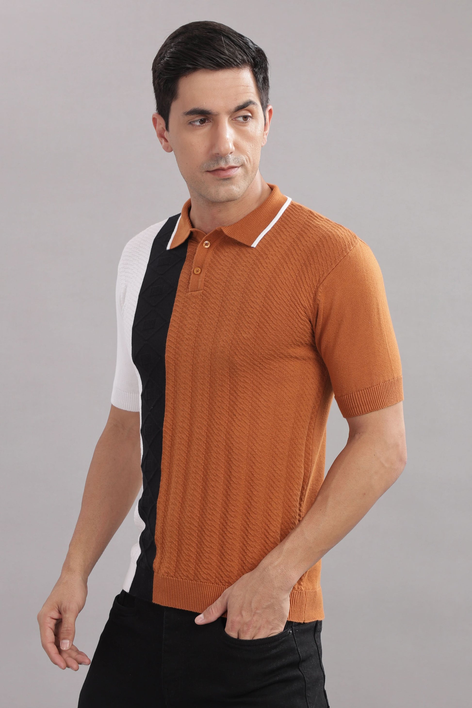 Men's cotton colour-block knitted polo shirt in rust, black, and white by Outlaws Fashion, shown in a close-up of the fabric and design.