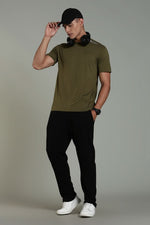 Olive green men's athleisure T-shirt by Outlaws Fashion, featuring a comfortable fit and sporty design, shown on a model.