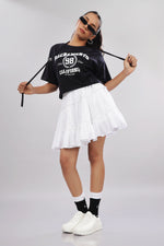 Black cotton boxy top for women with printed design and extended sleeves, stylishly worn by a model.
