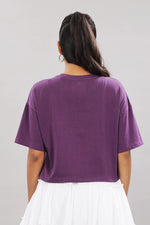Printed purple cotton boxy top for women with extended sleeves, showcasing a relaxed fit and vibrant floral design.