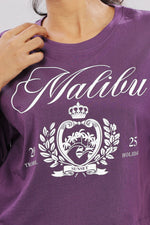 Printed purple cotton boxy top for women with extended sleeves, showcasing relaxed fit and vibrant floral print.